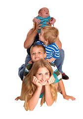 Image showing Pyramid of four kids on floor.