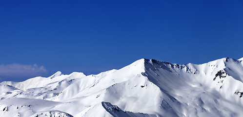 Image showing Panoramic view on off-piste snowy slope at sunny day