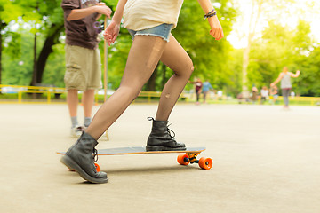 Image showing Teenage girl urban long board riding.