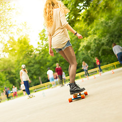 Image showing Teenage girl urban long board riding.