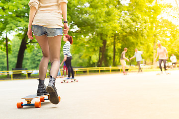 Image showing Teenage girl urban long board riding.