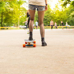 Image showing Teenage girl urban long board riding.