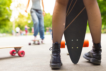 Image showing Teenage girl urban long board riding.