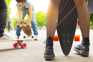 Image showing Teenage girl urban long board riding.