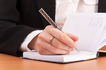 Image showing Business woman writing in notebook