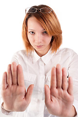 Image showing Attractive red-haired lady making stop gesture