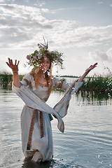 Image showing Beautiful woman with flower wreath in water