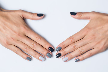 Image showing Hand with a stylish gray manicure isolated on white background