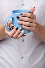 Image showing Female hands with blue cup