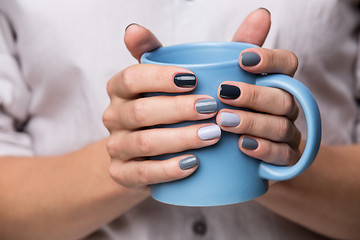 Image showing Female hands with blue cup