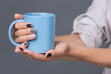 Image showing Female hands with blue cup