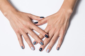 Image showing Hand with a stylish gray manicure isolated on white background