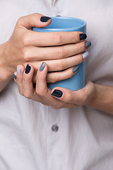 Image showing Female hands with blue cup