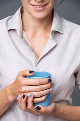 Image showing Female hands with blue cup