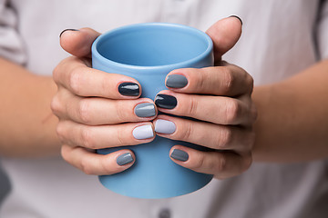 Image showing Female hands with blue cup