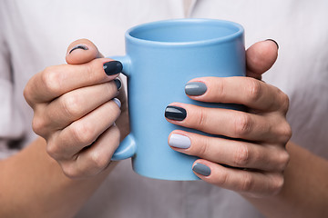 Image showing Female hands with blue cup