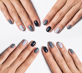 Image showing Hand with a stylish gray manicure isolated on white background