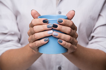 Image showing Female hands with blue cup