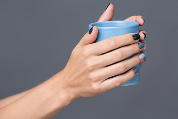 Image showing Female hands with blue cup