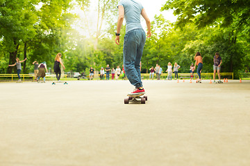 Image showing Girl practicing urban long board riding.