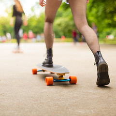 Image showing Teenage girl urban long board riding.