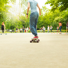 Image showing Teenage girl practicing riding long board.