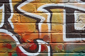 Image showing Bright graffiti on a peeling wall