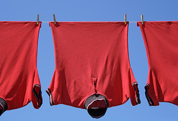 Image showing Laundry closeup, three red t-shirts