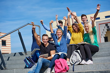 Image showing students outside sitting on steps