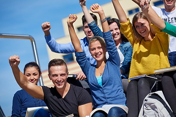 Image showing students outside sitting on steps