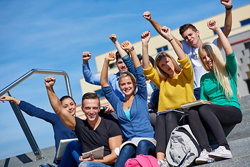 Image showing students outside sitting on steps