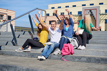 Image showing students outside sitting on steps