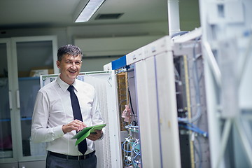 Image showing network engineer working in  server room