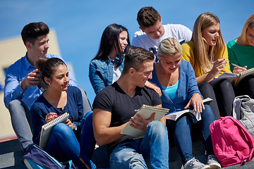 Image showing students outside sitting on steps