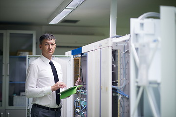 Image showing network engineer working in  server room