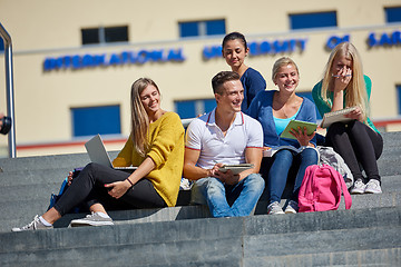 Image showing students outside sitting on steps