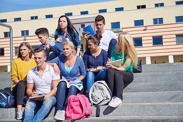 Image showing students outside sitting on steps