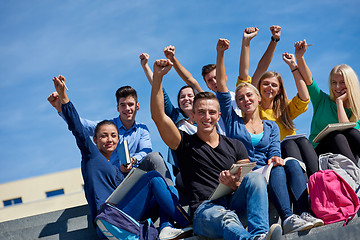 Image showing students outside sitting on steps