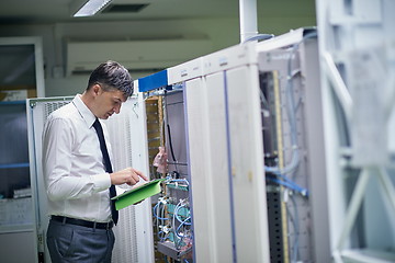 Image showing network engineer working in  server room