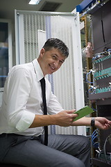 Image showing network engineer working in  server room