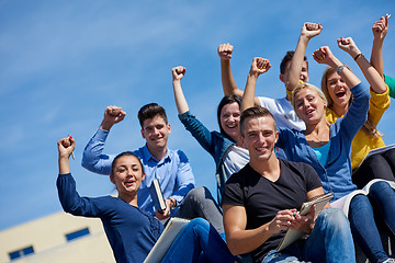 Image showing students outside sitting on steps