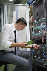 Image showing network engineer working in  server room