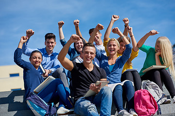 Image showing students outside sitting on steps