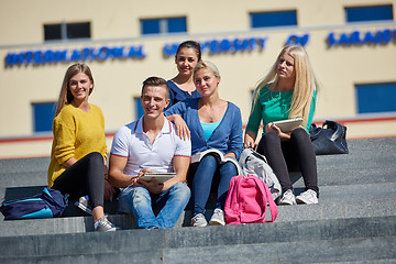 Image showing students outside sitting on steps