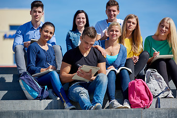 Image showing students outside sitting on steps