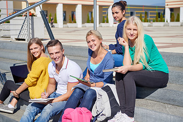 Image showing students outside sitting on steps