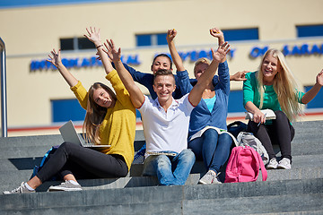 Image showing students outside sitting on steps