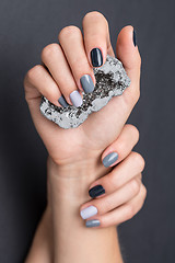 Image showing Female hands with textured silver mineral