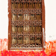 Image showing red   window in morocco africa old construction and brown wall  
