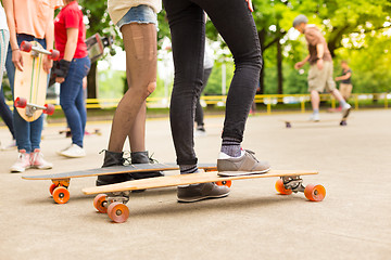 Image showing Teenage girl practicing riding long board.